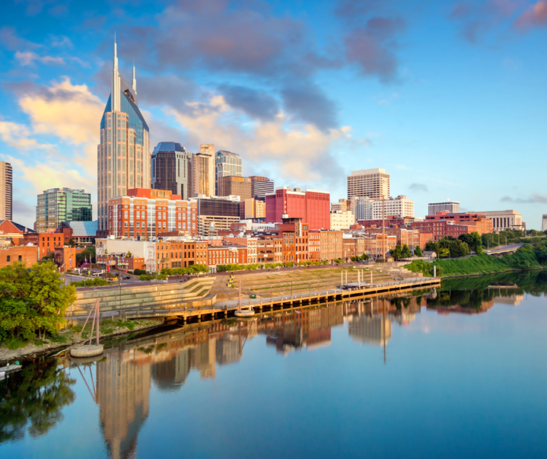 Nashville Tennessee downtown skyline with AT&T building reflected in the Cumberland River at golden hour